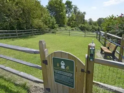 a fence with a sign in front of a field at pb 824 Furnished 2br Pool Gym Parking pb in Newark