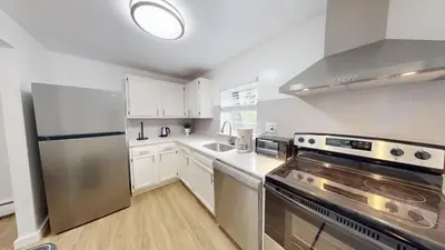 a kitchen with white cabinets and a stainless steel refrigerator at pb 824 Furnished 2br Pool Gym Parking pb in Newark