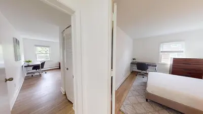 a bedroom with a bed and a desk in a room at pb 824 Furnished 2br Pool Gym Parking pb in Newark