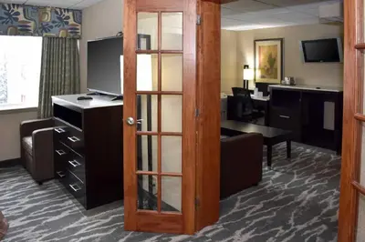 a hotel room with a door leading to a desk at Quality Inn East Stroudsburg - Poconos in East Stroudsburg
