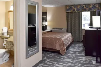 a hotel room with a bed and a television at Quality Inn East Stroudsburg - Poconos in East Stroudsburg