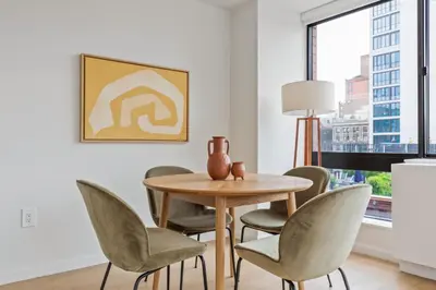 a dining room with a table and chairs at UWS 2BR w Elevator Gym DM Playroom Rooftop NYC-868 in New York