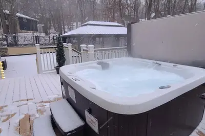 a large bath tub with snow on top of it at Luxury getaway in woods, Jacuzzi, Hot Tub, Pool in Bushkill