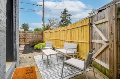 a patio with four chairs and a fence at Cozy Retreat in Downtown Lancaster with Backyard Patio in Lancaster