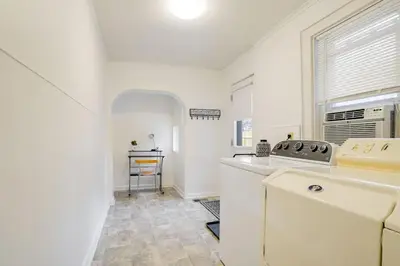 a white kitchen with a sink and a window at Cozy Retreat in Downtown Lancaster with Backyard Patio in Lancaster