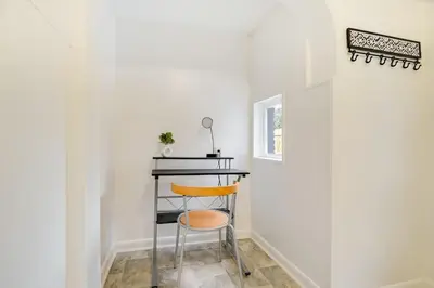 a stool in a room with a table and a window at Cozy Retreat in Downtown Lancaster with Backyard Patio in Lancaster