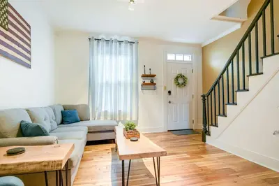 a living room with a couch and a table at Cozy Retreat in Downtown Lancaster with Backyard Patio in Lancaster