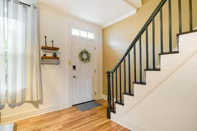 a staircase in a home with a white door at Cozy Retreat in Downtown Lancaster with Backyard Patio in Lancaster