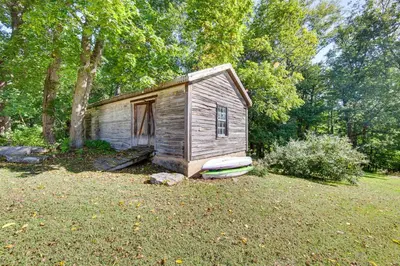 a small shack in a field with a tree at Jim Croces Farmhouse Apartment in Downingtown! in Downingtown
