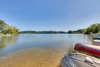 a boat sitting on the shore of a lake at Jim Croces Farmhouse Apartment in Downingtown! in Downingtown