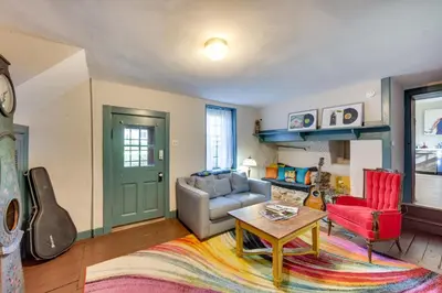 a living room with a couch and a table at Jim Croces Farmhouse Apartment in Downingtown! in Downingtown