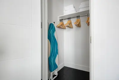 a walk in closet with a blue shower curtain and shoes at Midtown 2br w doorman wd nr Central Park NYC-1246 in New York