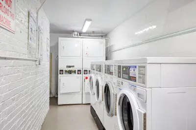a laundry room with two washes and two refrigerators at Midtown 2br w doorman wd nr Central Park NYC-1246 in New York
