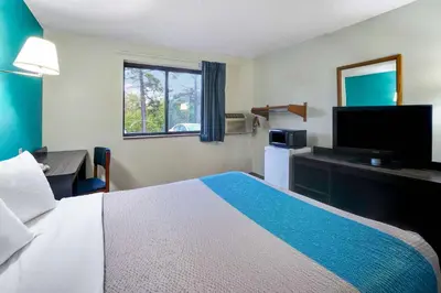 a hotel room with a bed and a flat screen tv at Motel 6-Montoursville, PA - Williamsport in Williamsport