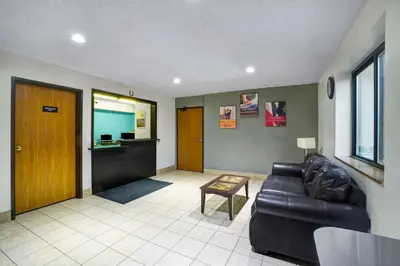 a living room with a couch and a table at Motel 6-Montoursville, PA - Williamsport in Williamsport