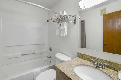 a bathroom with a sink and a toilet and a mirror at Motel 6-Montoursville, PA - Williamsport in Williamsport