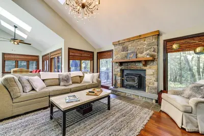 a living room with a couch and a fireplace at Pocono Pines Gem with Fire Pit and On-Site Creek! in Pocono Pines