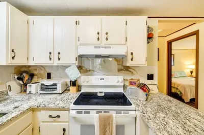 a kitchen with white cabinets and a stove at Hike, Swim, Ski and More Home in Arrowhead Lakes! in Pocono Lake
