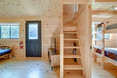a log cabin with bunk beds and a blue door at Catskills Tiny Home Cabin Surrounded by Nature! in Franklin