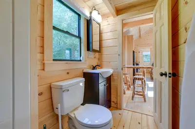 a bathroom in a tiny house with a toilet and a sink at Catskills Tiny Home Cabin Surrounded by Nature! in Franklin