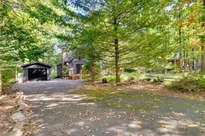 a driveway leading to a house with a garage at Community Beach Access Modern Poconos Cabin! in Albrightsville