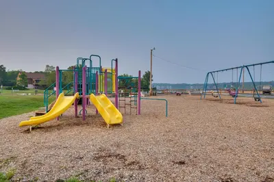 a playground with a slide in a park at Community Beach Access Modern Poconos Cabin! in Albrightsville