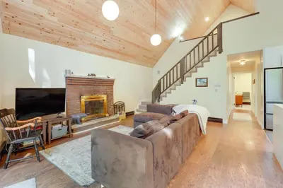 a living room with a couch and a fireplace at Community Beach Access Modern Poconos Cabin! in Albrightsville