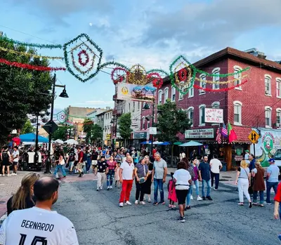 a crowd of people walking down a busy city street at Iron Bound Gem in Newark