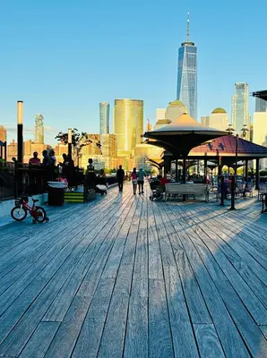 a boardwalk with people walking around in a city at Van Buren Gem 2.0 in Newark