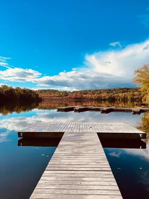a wooden dock on a body of water at Hudson Valley Cottage Rental 3 bedrooms Monroe NY in Monroe