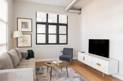 a living room with a couch and a tv at Sosuite at The Vine - Old City in Philadelphia