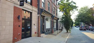 a street with a brick building and a street sign at Sosuite at The Vine - Old City in Philadelphia