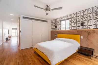 a bedroom with a bed and a ceiling fan at Eden, dream high-end home in NYC in New York