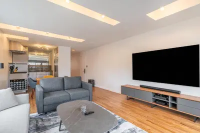 a living room with a large flat screen tv at Eden, dream high-end home in NYC in New York