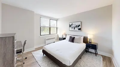 a bedroom with a bed and a desk and a window at Avenue A310 Furnished 2br With Pool And Gym in Philadelphia