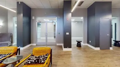 a room with two chairs and a hallway with doors at Avenue A310 Furnished 2br With Pool And Gym in Philadelphia