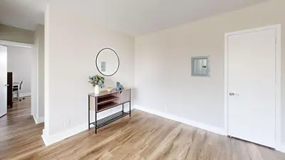 a white room with a table and a mirror at Avenue A310 Furnished 2br With Pool And Gym in Philadelphia