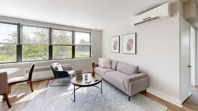 a living room with a couch and a table at Avenue A310 Furnished 2br With Pool And Gym in Philadelphia