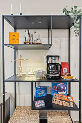 a black shelving unit with items on it at 1 BR Passyunk Ave Stunner- Perfect Location in Philadelphia