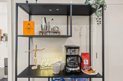 a shelf with a coffee maker and a doll on it at 1 BR Passyunk Ave Stunner- Perfect Location in Philadelphia