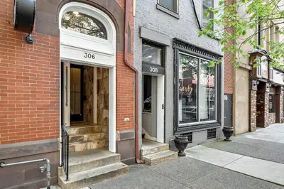 an empty street with a building with a store at Charming HBG Haven: Cozy 1BR Apt in Harrisburg