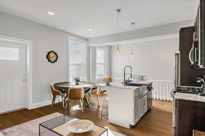 a kitchen and dining room with a table and a sink at Charming HBG Haven: Cozy 1BR Apt in Harrisburg