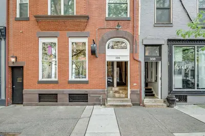 a brick building with an entrance to a store at Charming HBG Haven: Cozy 1BR Apt in Harrisburg