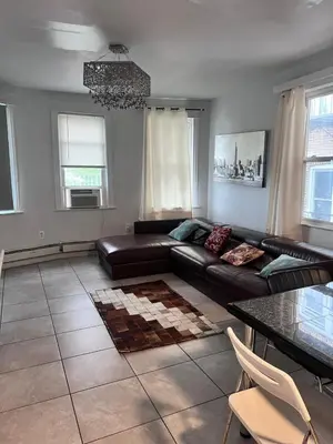 a living room with a couch and a table at Skyline 3BR 20 MIN to T Square #2 in West New York