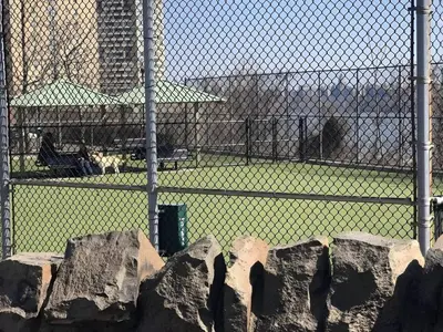 a cage with rocks in front of a fence at Skyline 3BR 20 MIN to T Square #2 in West New York