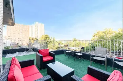 a patio with chairs and tables on a balcony at Skyline 3BR 20 MIN to T Square #2 in West New York