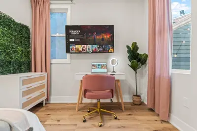 a bedroom with a desk and a chair with a laptop at Passyunk Square Spacious 1 BR Oasis- Huge Deck in Philadelphia