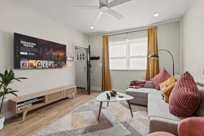 a living room with a couch and a table at Passyunk Square Spacious 1 BR Oasis- Huge Deck in Philadelphia