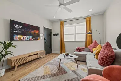 a living room with a couch and a table at Passyunk Square Spacious 1 BR Oasis- Huge Deck in Philadelphia