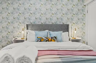 a bedroom with a large bed with two night stands at Passyunk Square Spacious 1 BR Oasis- Huge Deck in Philadelphia